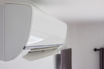 Air conditioner on white wall room interior background