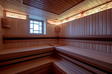Wooden sauna with modern lighting
