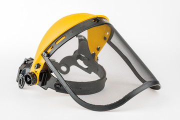 Yellow construction mask-grid on a wooden table on a white background.