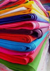 Bundles of colorful cloth arranged by folding