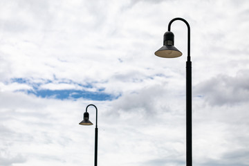 beautiful street lamps against the blue sky with white clouds