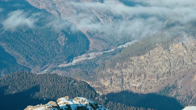 Mountain valley with a river in the clouds in sunny weather, Caucasus mountains