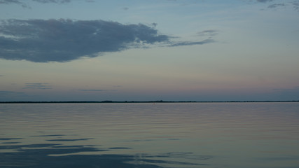 Fototapeta premium single cloud over reflective calm lake