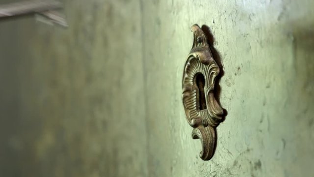 Close-up key in old wardrobe lock shallow DOF 4K video