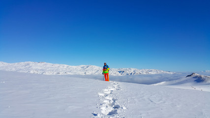 Naklejka na ściany i meble A skier and mountaineer in the snowy mountains, winter season 