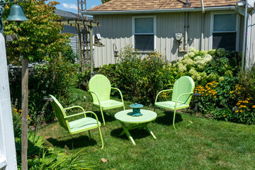 Green garden table and seating at cottage