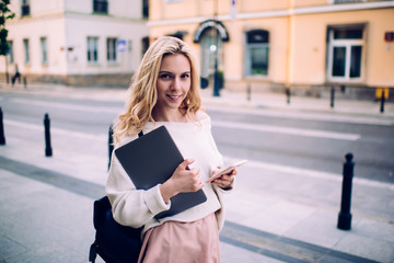 Smiling student with folder looking at camera