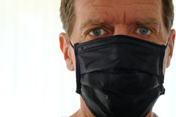 Head shot of middle aged caucasian man wearing Covid 19  facemask
