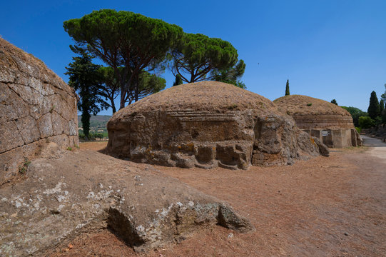 Ancient Etruscan funerary city, detail of the tumulus tomb. The Banditaccia necropolis located on a tuffaceous hill north-west of Cerveteri, near Rome photographed on a sunny summer day. Italy.