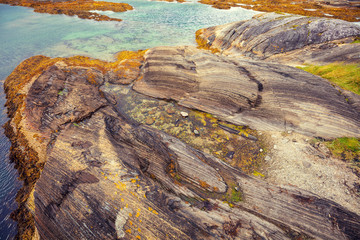 Rocky seashore. Rocky texture, stone coastline. View of a fjord. Norway, Europe