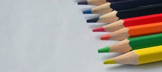 A set of colored pencils for drawing on a white background. Colors, art.