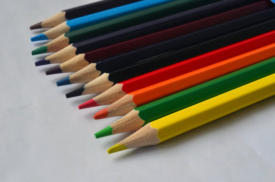 A set of colored pencils for drawing on a white background. Colors, art.