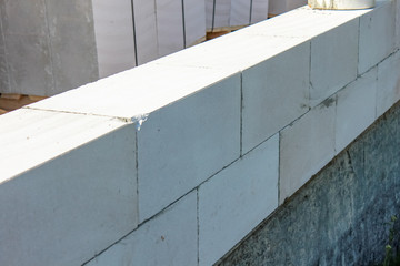 Street lighting. Start building a white block residential building. Laying takes place on an adhesive base