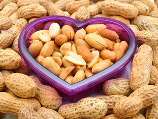 Processed peanuts isolated in bowl  over peanuts background