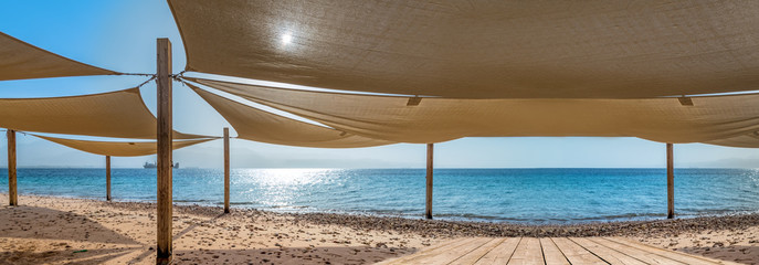 Resting and recreational area with sunshades at a sandy beach of the Red Sea,  Middle East
