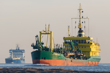 Obraz premium HOPPER DREDGER - A specialized vessel travels on a waterway at sea 
