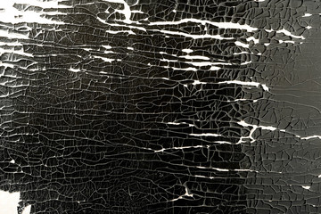 Wood surface with peeling black paint