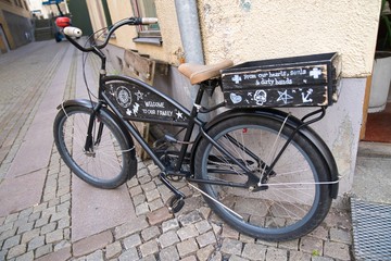 Fototapeta na wymiar Cute black bicycle parked on the street corner
