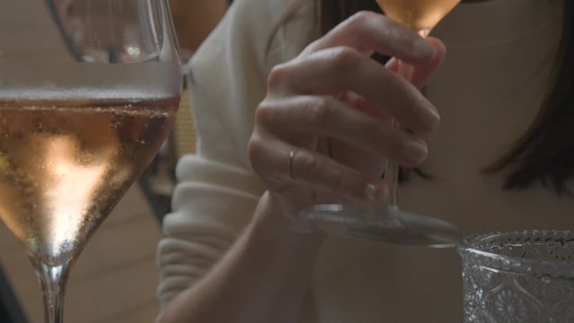 Close up of a woman drinking a sparkling wine