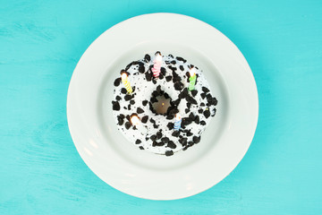 donut with candles on a plate