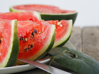 Enlarged view. Food background. Slices of ripe red watermelon on a wooden table.