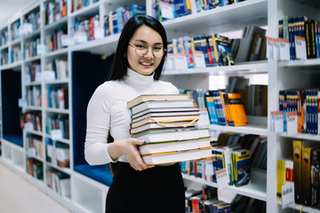 Asian happy woman buying books in bookstore