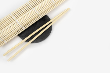 Japanese kitchen background with bamboo mat, chopsticks, soy sauce