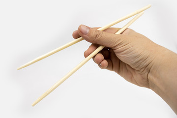 Woman using chopsticks, bamboo chopsticks for asian food