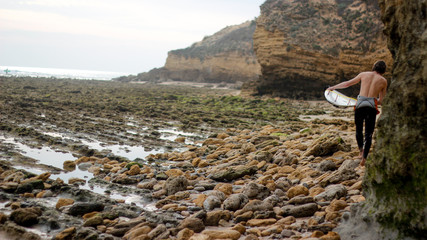surfer walking on the rocks © juanignacio