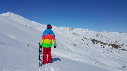 a young skier skiing on the mountain, winter season and snow landscape
