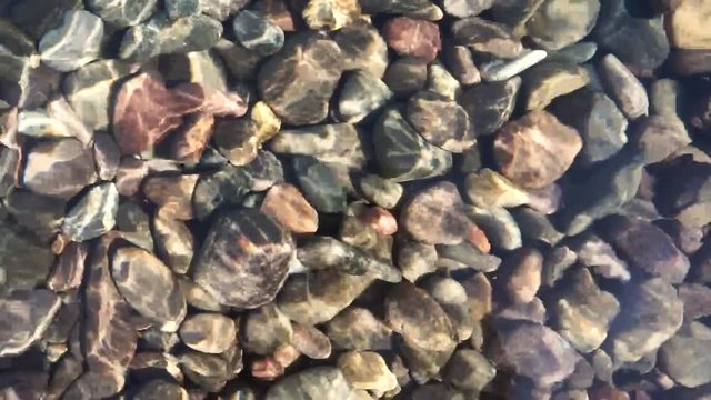 Pebble background under the sea water
