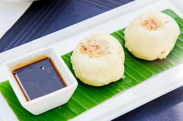 Japanse cuisine, squid on plate with soy sauce for lunch menu