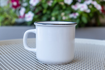 Coffee cup mockup on a table, blur green background.