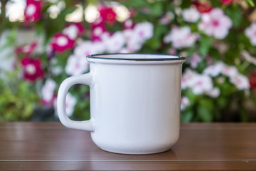 Coffee cup mockup on a table, blur green background.