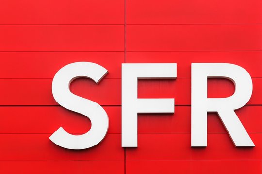 Orleans, France - March 19 2017: SFR logo on a wall. SFR is a French telecommunications company that provides voice, video, data, and Internet telecommunications and professional services to consumers