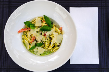 Italian Wholemeal Pasta Tagliatelle with Salmon and Parsley. Fresh pasta with smoked salmon in the sauce on white wooden background with place for text. Italian cuisine concept. Copy space. Top view.