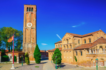 Fototapeta na wymiar Church of Santa Maria e San Donato and bell tower brick building on Campo San Donato square
