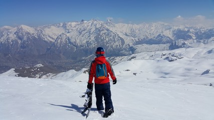 Fototapeta na wymiar a young skier skiing on the mountain, winter season and snow landscape 