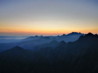 Naklejka na ściany i meble The contours of the mountain peaks at sunrise. Mountain peaks at sunrise. Tatra Mountains Poland.