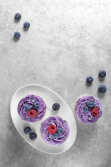 Cupcakes with cream on a white plate