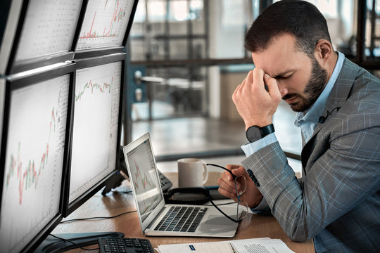 Tired trader checking global currency index on fund exchange