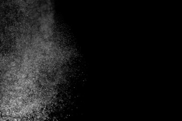 White dust on a black background, selective focus.
