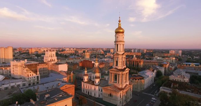 Aerial view to Holy Dormition Cathedral (Uspenskiy sobor) at sunset with panorama of Kharkiv city, Ukraine