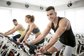 Group of people in spinning gym room