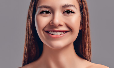 Beautiful wide smile of young fresh woman with great healthy white teeth. Isolated over background
