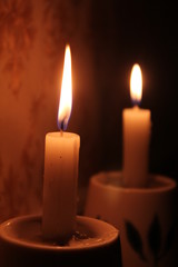 Two candles in the dark.
