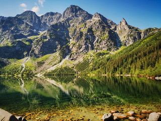 Morskie Oko has a view. Summer in the Tatras, holidays in the mountains. Poland Tatry. - obrazy, fototapety, plakaty