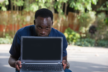 portrait of a young man with laptop.