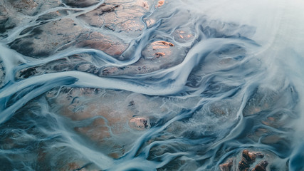 A glacial rivers from above. Aerial photograph of the river streams from Icelandic glaciers. Beautiful art of the Mother nature created in Iceland. Wallpaper background high quality photo - 373761222
