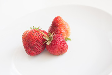  Appetizing strawberry from a home garden in a white terelka with copy space. Harvest season for strawberries and red berries. Allergy-free berry for raising immunity